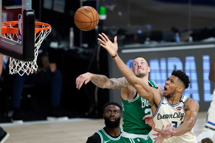 Milwaukee Bucks' Giannis Antetokounmpo, right, heads to the basket as Boston Celtics' Daniel Theis defends during the second half of an NBA basketball game Friday, July 31, 2020,